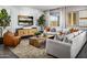 Cozy living room with large sofa, stylish decor, and a view of the outdoors at 12642 W Parkway Ln, Avondale, AZ 85323