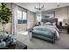A serene main bedroom featuring a queen-sized bed, soft lighting, and a picturesque window view at 12642 W Parkway Ln, Avondale, AZ 85323