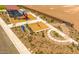 Aerial view of a community play area with a covered playground, hopscotch, and circular numbered pathway at 12651 W Parkway Ln, Avondale, AZ 85323