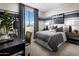 Comfortable bedroom featuring a bed, desk with a view, and stylish blue-striped accent walls at 12651 W Parkway Ln, Avondale, AZ 85323