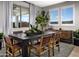 Elegant dining room with wooden table, leather chairs, and natural light from the window at 12651 W Parkway Ln, Avondale, AZ 85323