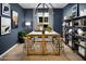 Stylish home office featuring a large marble top table, bookshelves, and natural light at 12651 W Parkway Ln, Avondale, AZ 85323