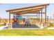 Community playground featuring a covered picnic area, with benches and a large colorful climbing structure at 12651 W Parkway Ln, Avondale, AZ 85323