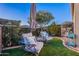 Cozy backyard with artificial turf, chairs, and a small table. Perfect for relaxing outdoors at 1275 E Verde Blvd, Queen Creek, AZ 85140