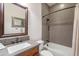 Bathroom showcasing modern tiling in shower/tub combination, updated fixtures and framed mirror at 1275 E Verde Blvd, Queen Creek, AZ 85140