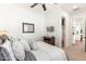 Bright bedroom featuring a ceiling fan, wall-mounted TV, and doorway to the bathroom at 1275 E Verde Blvd, Queen Creek, AZ 85140