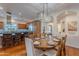 Dining room with a large table and decorative chandelier, open to the kitchen and living area at 1275 E Verde Blvd, Queen Creek, AZ 85140