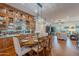 Elegant dining room with a large table, crystal chandelier, wood floors, and built-in mirrored cabinets at 1275 E Verde Blvd, Queen Creek, AZ 85140