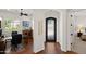 Elegant entryway with decorative wrought iron door, hardwood floors, and arched openings at 1275 E Verde Blvd, Queen Creek, AZ 85140