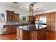 Spacious kitchen featuring dark wood cabinetry, stainless steel appliances, and large island at 1275 E Verde Blvd, Queen Creek, AZ 85140