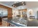 Kitchen island cooktop and dining area in an open layout at 1275 E Verde Blvd, Queen Creek, AZ 85140