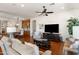 Inviting living room featuring hardwood floors, a ceiling fan, and a view into the dining area at 1275 E Verde Blvd, Queen Creek, AZ 85140
