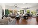 Cozy living room featuring neutral paint, hardwood floors, ceiling fans, and lots of natural light at 1275 E Verde Blvd, Queen Creek, AZ 85140
