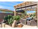 Relaxing outdoor pergola area with comfortable seating overlooking the pool and garden at 1275 E Verde Blvd, Queen Creek, AZ 85140