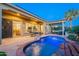 Sparkling backyard pool featuring travertine deck, desert landscape, and covered patio at 1275 E Verde Blvd, Queen Creek, AZ 85140