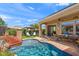 Backyard pool featuring a rock waterfall and lush landscaping at 1275 E Verde Blvd, Queen Creek, AZ 85140