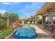 Beautiful backyard pool area with a stone waterfall and landscaped surroundings at 1275 E Verde Blvd, Queen Creek, AZ 85140