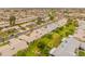 An aerial view of a neighborhood featuring green grass and well-maintained landscaping at 13026 W Peach Blossom Dr, Sun City West, AZ 85375