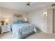 Charming bedroom featuring a cozy bed, ceiling fan, and white closet, creating a peaceful retreat at 13026 W Peach Blossom Dr, Sun City West, AZ 85375