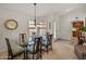 Cozy dining room features a glass table and modern decor, with natural light and views at 13026 W Peach Blossom Dr, Sun City West, AZ 85375