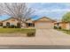 Inviting single-story home with a desert landscape, long driveway and an attached two-car garage at 13026 W Peach Blossom Dr, Sun City West, AZ 85375