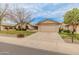 Inviting single-story home with a desert landscape, long driveway and an attached two-car garage at 13026 W Peach Blossom Dr, Sun City West, AZ 85375