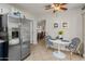 Bright eat-in kitchen with stainless steel refrigerator and a view of the dining room at 13026 W Peach Blossom Dr, Sun City West, AZ 85375