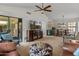 Comfortable living space opens to dining area and features a vaulted ceiling and a view of the backyard at 13026 W Peach Blossom Dr, Sun City West, AZ 85375