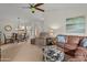 Open-concept living space flows into the dining area, featuring comfortable seating and a bright atmosphere at 13026 W Peach Blossom Dr, Sun City West, AZ 85375