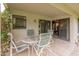 Covered patio with dining table set and sliding glass doors for seamless indoor-outdoor living at 13026 W Peach Blossom Dr, Sun City West, AZ 85375