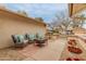 Inviting patio with comfortable seating, potted plants, and a peaceful atmosphere, perfect for relaxing outdoors at 13026 W Peach Blossom Dr, Sun City West, AZ 85375