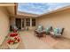 Inviting patio with comfortable seating, potted plants, and a peaceful atmosphere, perfect for relaxing outdoors at 13026 W Peach Blossom Dr, Sun City West, AZ 85375