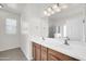 Bright bathroom with a double sink vanity, large mirror, and neutral walls at 1316 E Spencer St, Casa Grande, AZ 85122