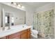 Bathroom with a double vanity and a shower with a floral curtain at 1316 E Spencer St, Casa Grande, AZ 85122