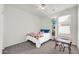 Bright bedroom featuring a bed, table, and bookshelf with neutral walls at 1316 E Spencer St, Casa Grande, AZ 85122