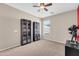 Bright bedroom featuring neutral walls, ceiling fan, carpet floors, and bookcases at 1316 E Spencer St, Casa Grande, AZ 85122