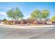 Inviting Arroyo Vista community entrance with brick signage, mature trees, and well-maintained landscaping at 1316 E Spencer St, Casa Grande, AZ 85122