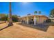 Relaxing backyard featuring a covered patio, table and chair set, and desert landscaping at 13621 N Emberwood Dr, Sun City, AZ 85351