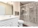 Updated bathroom with a glass shower enclosure, and a sleek vanity with a white countertop at 13621 N Emberwood Dr, Sun City, AZ 85351