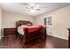 Bedroom featuring a ceiling fan, wood floors and shuttered windows at 13621 N Emberwood Dr, Sun City, AZ 85351