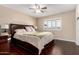 Bedroom with a ceiling fan, wood floors, and large dresser at 13621 N Emberwood Dr, Sun City, AZ 85351