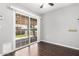 Bright bedroom with sliding glass doors leading to the outdoors and wood floors at 13621 N Emberwood Dr, Sun City, AZ 85351