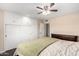 Bedroom features a ceiling fan, built in cabinets, and wood floors at 13621 N Emberwood Dr, Sun City, AZ 85351