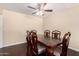 Traditional dining room featuring a ceiling fan, and a large wooden dining table with seating for six at 13621 N Emberwood Dr, Sun City, AZ 85351