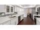 Kitchen with white cabinets, stainless steel appliances and a mosaic backsplash at 13621 N Emberwood Dr, Sun City, AZ 85351