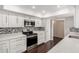 Kitchen with white cabinets, stainless steel appliances and mosaic backsplash at 13621 N Emberwood Dr, Sun City, AZ 85351