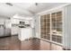 Open kitchen area with white cabinets, breakfast bar, and access to the backyard at 13621 N Emberwood Dr, Sun City, AZ 85351