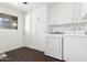 Laundry room with washer and dryer with built-in cabinets at 13621 N Emberwood Dr, Sun City, AZ 85351