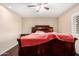 Bedroom with a ceiling fan, wood floors and shuttered windows for natural light at 13621 N Emberwood Dr, Sun City, AZ 85351