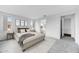 Brightly-lit primary bedroom featuring neutral walls and carpet, view to ensuite at 14315 W Calle Lejos Rd, Surprise, AZ 85387